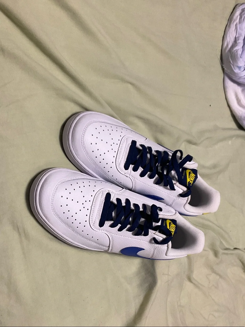 Nike White Sneakers with Navy Accents and Yellow Logo